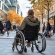 © jakkrit - Urban Autumn Stroll: A young woman in a wheelchair navigates a bustling city street amidst the vibrant colors of fall. This image embodies themes of accessibility, inclusion, and the everyday lives of