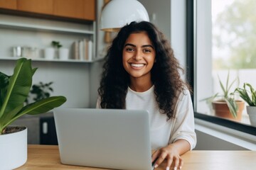 Canvas Print - Woman works laptop computer smiling.