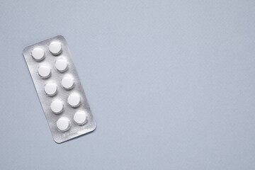 Wall Mural - Antibiotic pills in blister on gray background, top view. Space for text