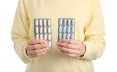 Wall Mural - Woman holding blisters with antibiotic pills on white background, closeup