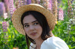 © schankz - Portrait of a brunette girl in a straw hat outdoors in summer