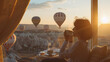 © VK Studio - A person enjoying a serene moment, sipping a hot drink while gazing at hot air balloons drifting over a picturesque landscape at sunrise.