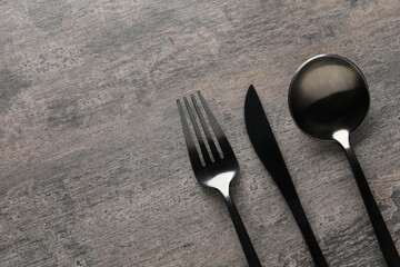 Poster - Stylish cutlery on grey table, flat lay. Space for text