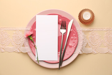 Wall Mural - Empty menu, tableware, candle and floral decor on beige table, top view. Mockup for design