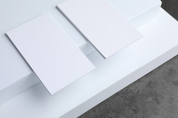 Wall Mural - Blank business cards on grey textured table. Mockup for design