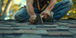 © Maximusdn - A roofer hammering shingles, with a focus on the repetitive motion and physical effort required.