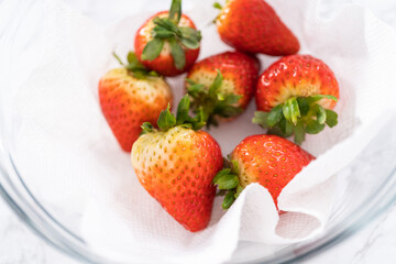 Poster - Washed and Dried Strawberries Neatly Stored in a Glass Bowl