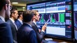 © Meow Creations - Group of focused stock traders analyzing real time financial data on multiple computer screens in a modern office.
