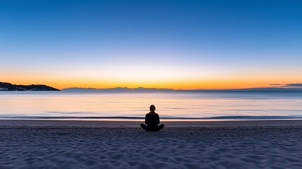 Wall Mural - Silhouette of a person sitting cross-legged on a serene beach during sunset, calm waves in the background, evoking a sense of mental clarity and emotional tranquility.
