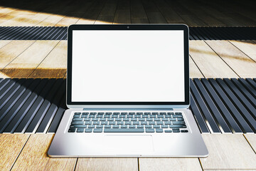 Poster - Modern laptop with blank screen on a wooden floor background. 3D Rendering