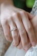 © LU - A close-up shot of a woman wearing a diamond wedding ring on her hand. Marriage and vows concept topics.