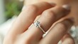 © LU - A close-up shot of a woman wearing a diamond wedding ring on her hand. Marriage and vows concept topics.