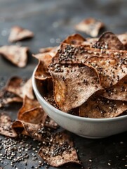 Wall Mural - a bowl of chips with a sprinkle of sesame seeds. the bowl is full of chips and the chips are scatter