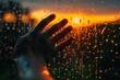 © Ольга Лукьяненко - Hand touching rain-soaked window at sunset