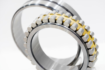 Poster - A silver and gold bearing. The bearing is made of metal and has a shiny surface, Industrial concept