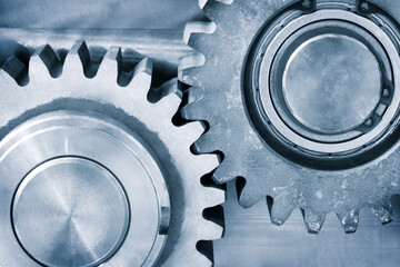 Poster - A gear is shown with a ball bearing in the center. The gear is part of a machine and is turning. ndustrial background concept