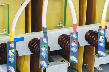 Poster - A group of electrical wires are connected to a yellow box. Each wire has a different colored label, including yellow, green, red, and blue