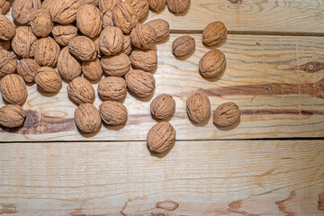 Wall Mural - Walnuts on a wooden table. View from above.