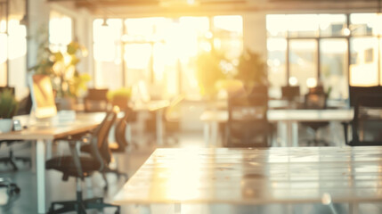 Wall Mural - Sunny modern office desk. A modern office space with a desk in the foreground and a blurred background of desks and chairs. Sunlight streams through the windows, creating a bright and airy atmosphere.