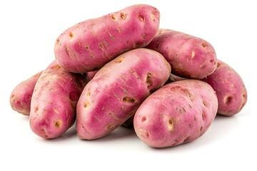 Fresh pink fingerling potatoes stacked on white background