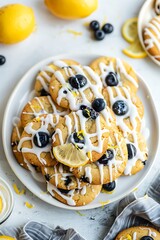 Canvas Print - Close-up of Lemon Blueberry Cookies with White Glaze and Lemon Zest on a White Plate.