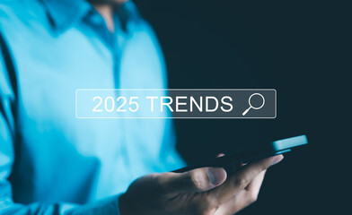 Wall Mural - Trends 2025 year concept. Businessman showing search engine bar with 2025 trends wording for marketing monitor and business planning in new year. Finding information and new ideas for doing business.