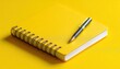 © ЮРИЙ ПОЗДНИКОВ - A bright yellow spiral notebook accompanied by a pen rests on a cheerful yellow background