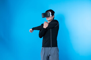 Smart gamer wearing VR turning to metaverse new world stretching arm for exercise healthy body isolated blue background connecting to futuristic technology virtual reality in meta city. Contrivance.