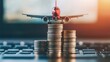 © hanafi 99d - Airplane on Coin Stacks: The Cost of Travel