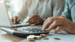 © forenna - Old Man and Woman Typing on a Calculator - Senior Couple Sitting in Living Room at Home, Calculating Domestic Finances and Budget, Coins on Desk, Financial Expenses and Tax Bills P