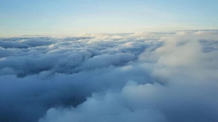 Wall Mural - a vast expanse of snowy clouds stretches out as far as the eye can see obscuring any trace of the gr