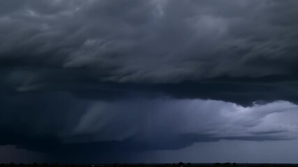 Canvas Print - A stark contrast of dark storm clouds and bright flashing lightning creates a dramatic electric storm scene.