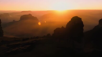 Canvas Print - The fading sunlight casts long shadows over the rugged terrain creating a dramatic contrast between light and dark.