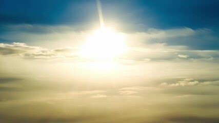 Poster - Beneath a thin cloud veil the sun casts dazzling rays of light creating a breathtaking display.