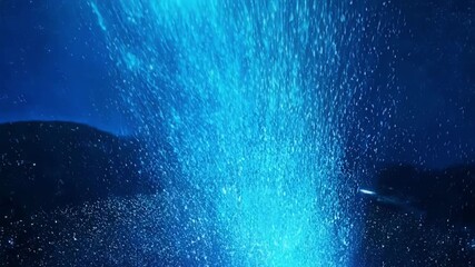 Wall Mural - Brilliant blue particles cascade down from the sky creating a dazzling spectacle.