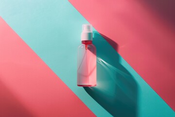 Wall Mural - A bottle of lotion sits on a pink and blue striped surface, ready for use