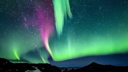 Wall Mural - The air is charged with an otherworldly energy as ethereal ribbons of pink turquoise and silver weave and twirl through the night sky creating a breathtaking mystical aurora.