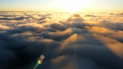 Poster - The magical moment when the world awakens and the suns rays dance across the endless expanse of clouds creating a captivating aerial view.