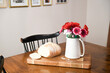 © amanda - Sliced bread and vase with flowers on a wooden table.