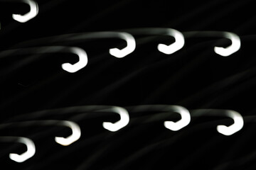Wall Mural - the image is a series of white lines that are curved and overlapping. the lines are black and white,