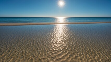 Calm ocean with clear sky and sun shining bright above