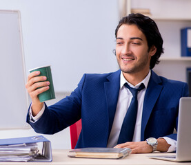 Wall Mural - Young handsome businessman working in the office