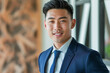 © N. W. - happy young and handsome asian business man in a suit smiling