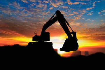 Wall Mural - Crawler excavators silhouette are digging the soil in the construction site on the sunrise background