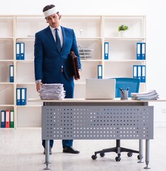 Wall Mural - Head injured male employee working in the office