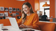 © Max - Happy Woman Smiling While Browsing Laptop and Enjoying Coffee in Monochromatic Orange Workspace