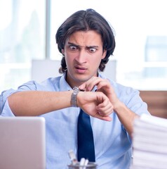 Wall Mural - Young employee unhappy with excessive work