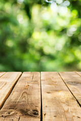Poster - Close-up view of wooden planks with a beautiful green bokeh background, perfect for natural, rustic, or outdoor themed projects and designs.