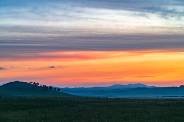 Wall Mural - Landscape of grassland and mountain under twilight