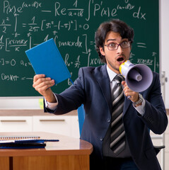 Wall Mural - Young male math teacher in classroom